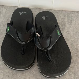 Black Sanuk flip flops